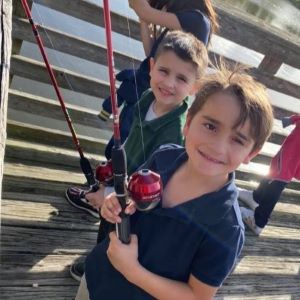 Young kids fishing on a dock with FFA.