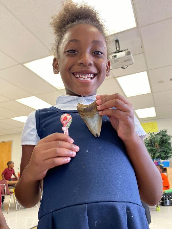 Young student with a shark tooth.