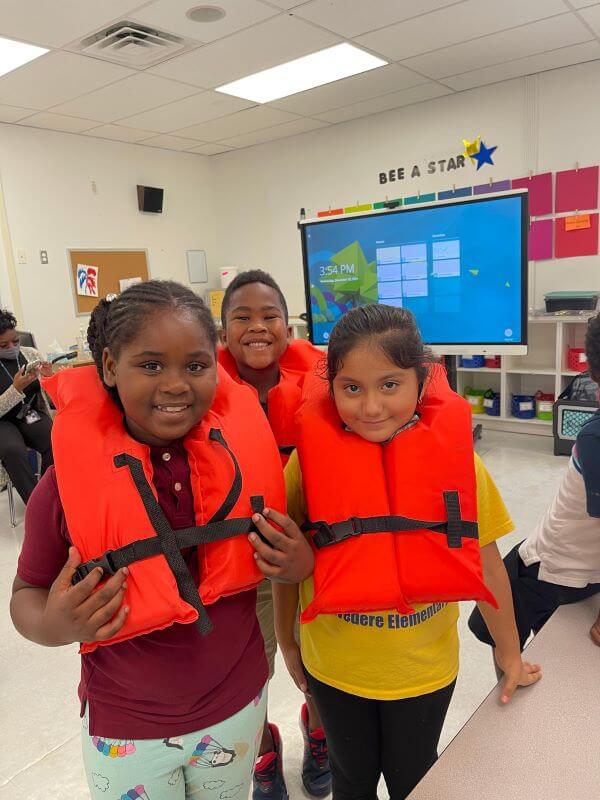 Learning about safety vests in class.