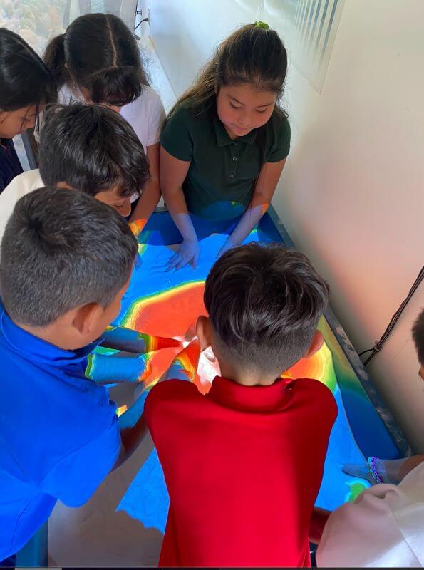 Students experimenting with the topography sandbox. 