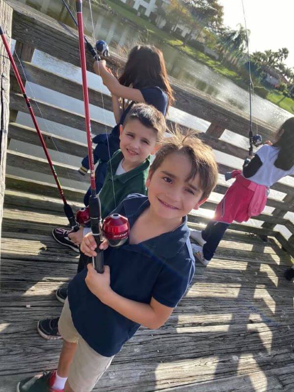 Young kids fishing off the dock in Palm Beach.